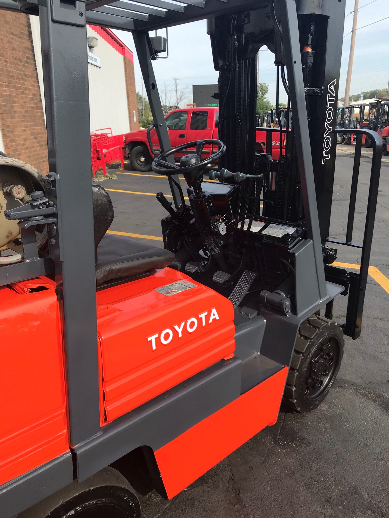Orange toyota forklift with 3 stage mast for rent